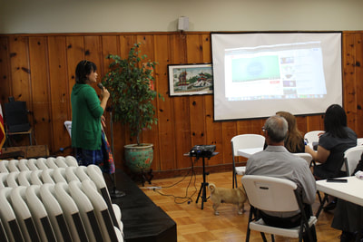 Woman presenting at Pacific Atrocities Education showcase